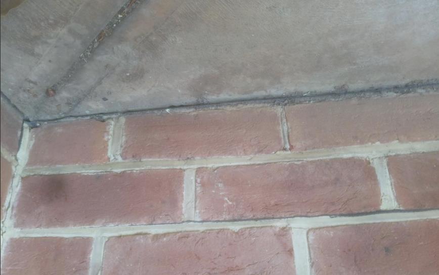 Cracking at the junction of masonry and a concrete element
